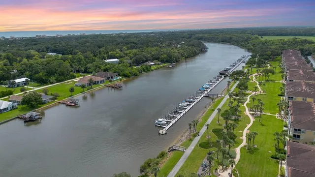 a view of a swimming pool with lawn chairs under an umbrella
