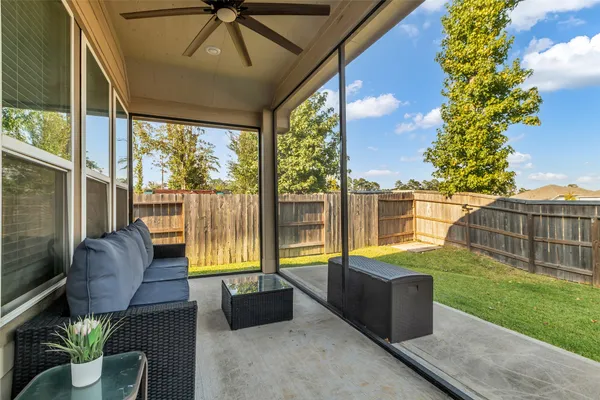 a view of a patio with a table and chairs