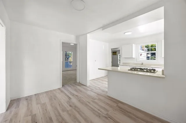 a view of kitchen with sink and refrigerator