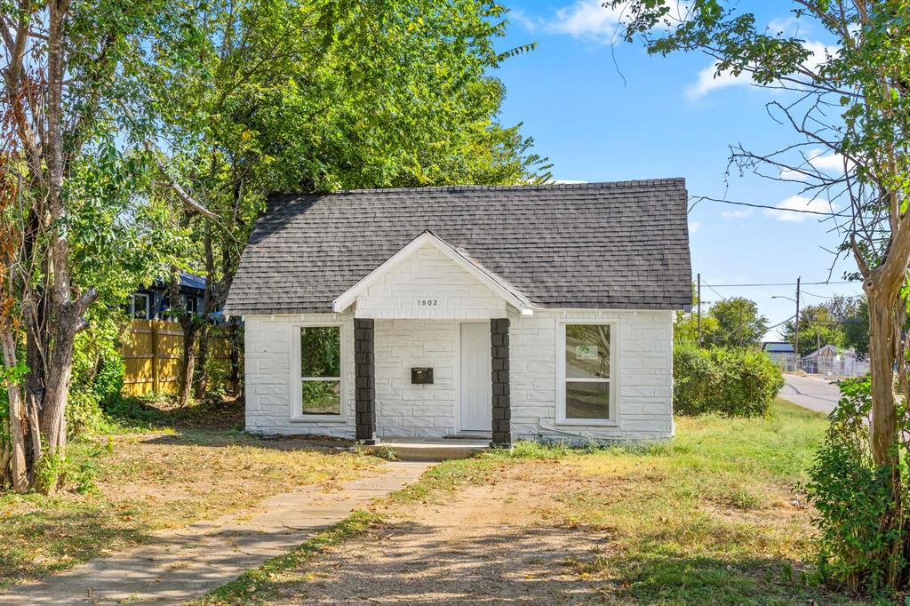1802 Fordham Road Dallas, TX 75216 - Photo 2 of 25 a front view of house with yard and trees around