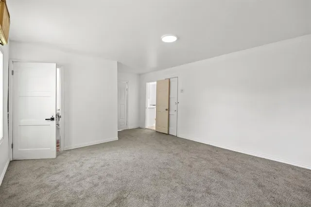 a view of an empty room and closet area