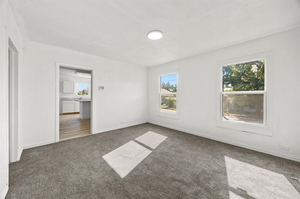 1802 Fordham Road Dallas, TX 75216 - Photo 5 of 25 an empty room with windows and entrance