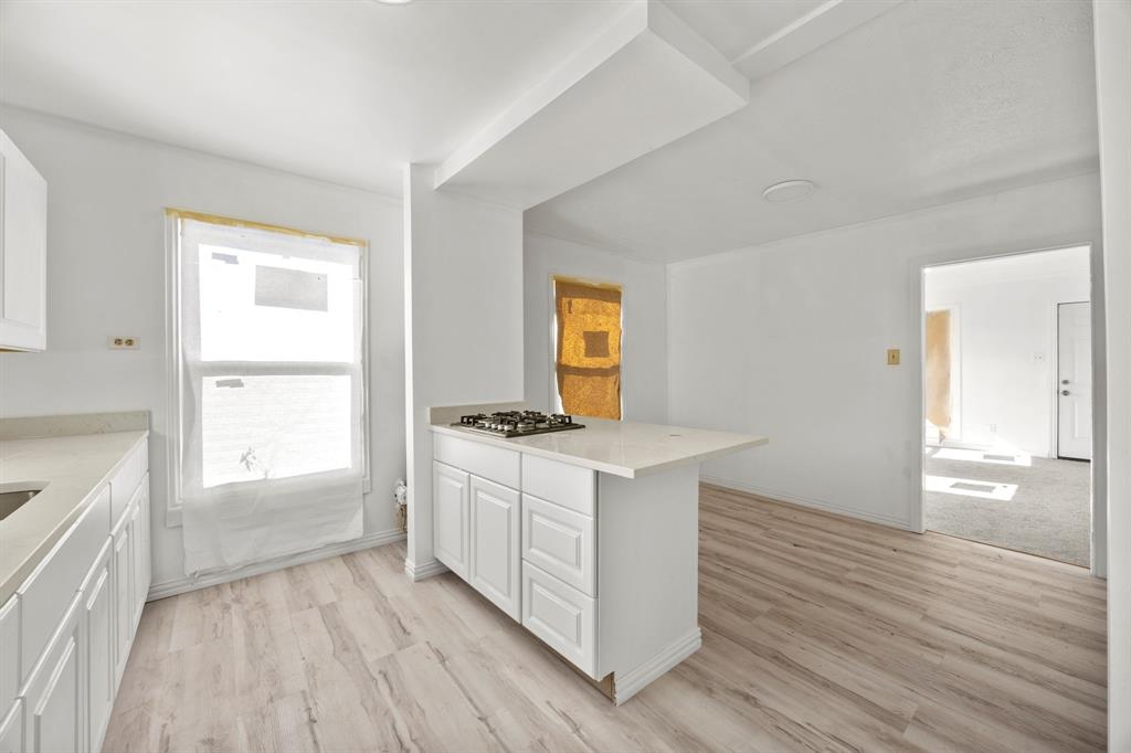 1802 Fordham Road Dallas, TX 75216 - Photo 8 of 25 a kitchen with stainless steel appliances granite countertop a stove a sink and a refrigerator