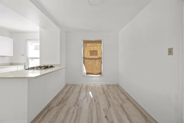a bathroom with a sink window and a mirror
