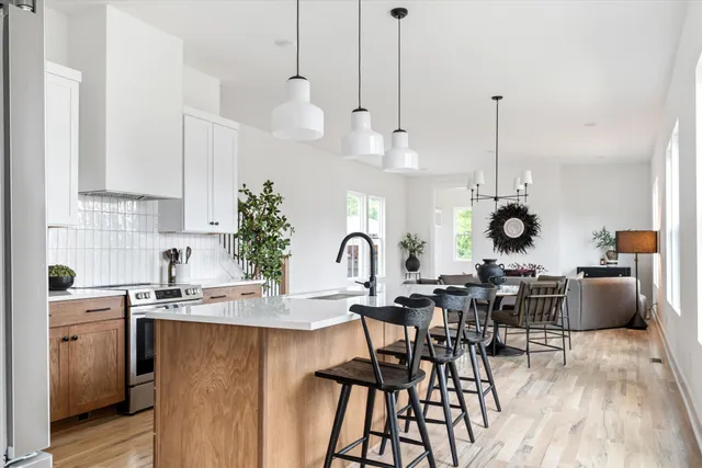 a view of a kitchen area with furniture and wooden floor