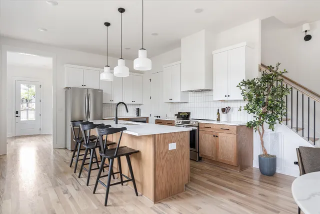 a kitchen with a table chairs sink and cabinets