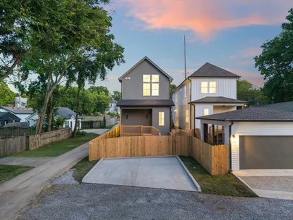 a view of a house with many windows and a yard