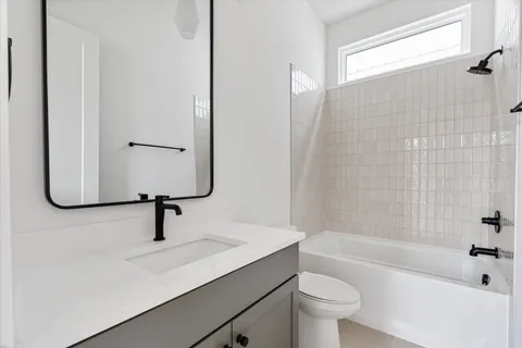 a bathroom with a sink toilet and bathtub