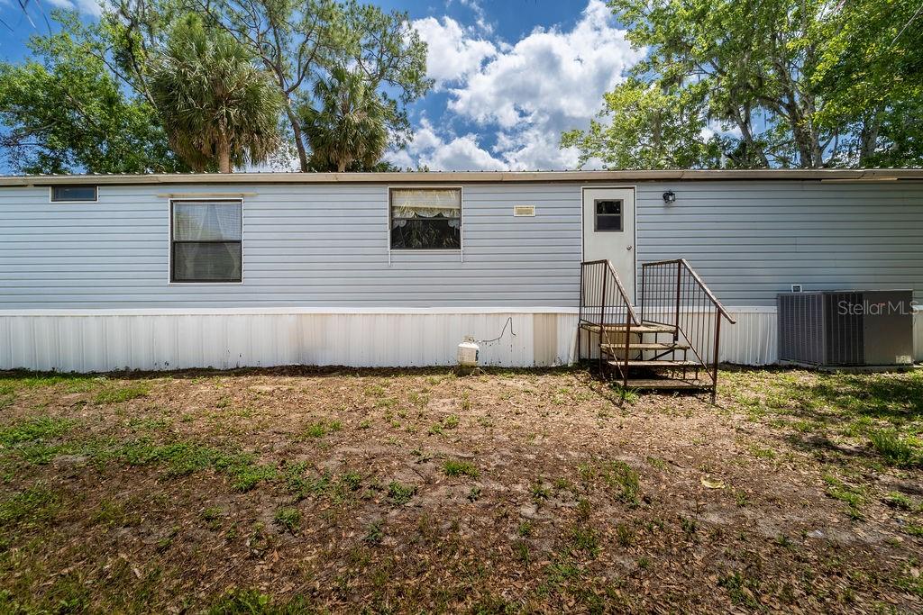 24031 Armadillo Road Astor, FL 32102 - Photo 41 of 43 a view of a house with a yard