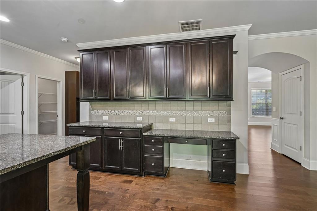 5378 Silverwoods Walk Powder Springs, GA 30127 - Photo 17 of 62 a kitchen with granite countertop stainless steel appliances and wooden cabinets