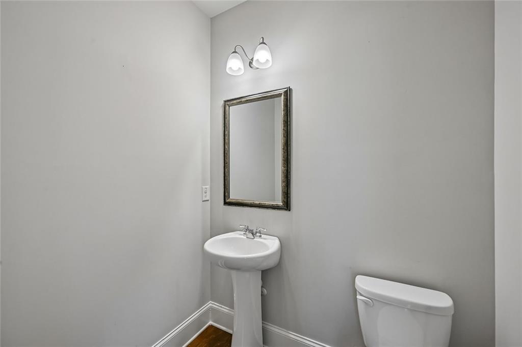 5378 Silverwoods Walk Powder Springs, GA 30127 - Photo 18 of 62 a bathroom with a toilet sink vanity and mirror