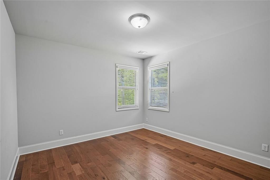 5378 Silverwoods Walk Powder Springs, GA 30127 - Photo 20 of 62 an empty room with wooden floor and windows