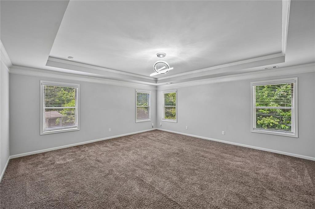5378 Silverwoods Walk Powder Springs, GA 30127 - Photo 25 of 62 an empty room with windows and chandelier fan