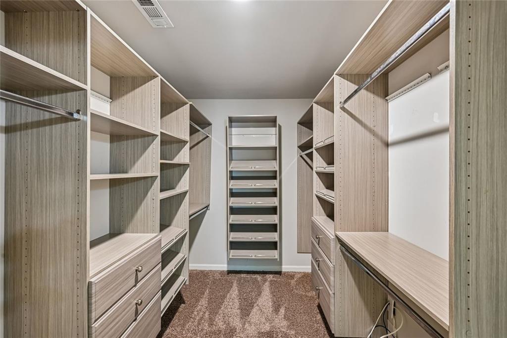 5378 Silverwoods Walk Powder Springs, GA 30127 - Photo 32 of 62 a view of walk in closet with empty racks