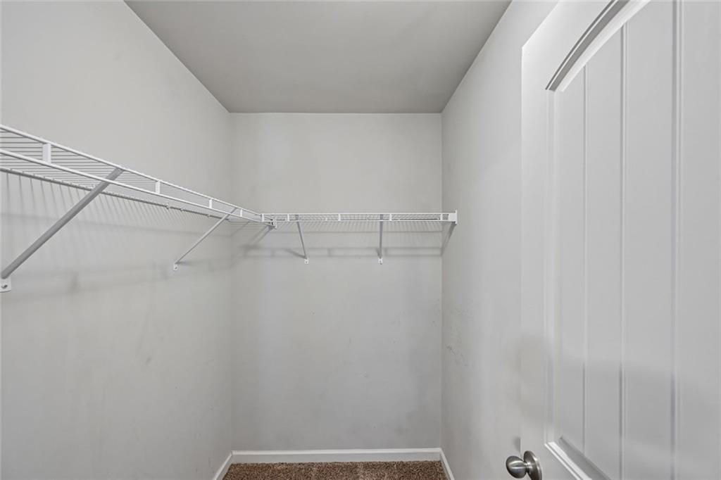 5378 Silverwoods Walk Powder Springs, GA 30127 - Photo 36 of 62 a view of a room with racks on the wall
