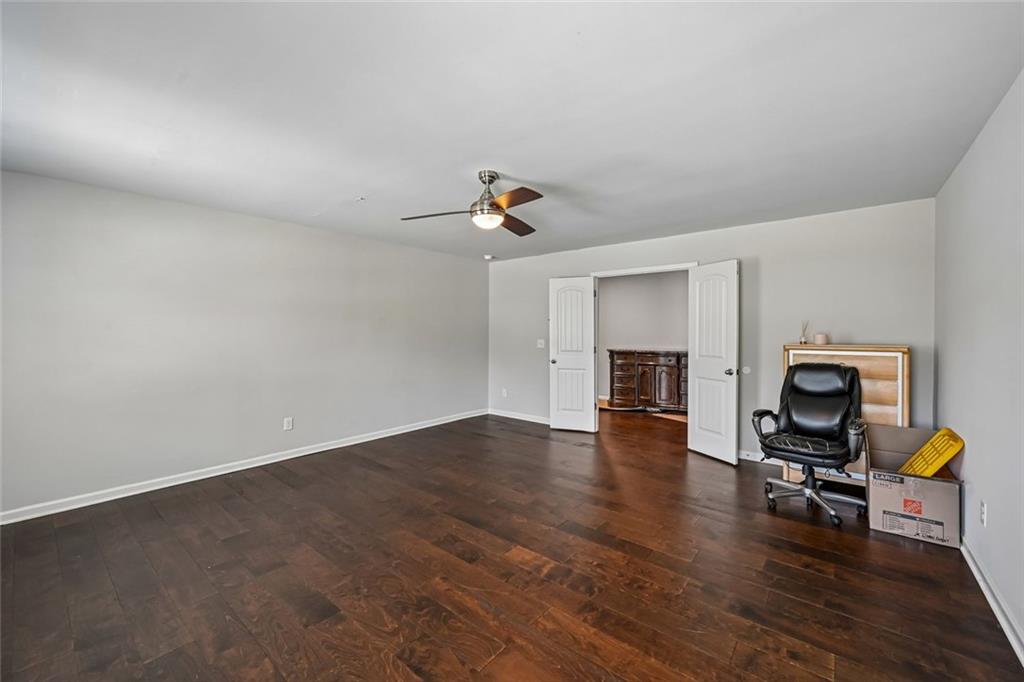 5378 Silverwoods Walk Powder Springs, GA 30127 - Photo 43 of 62 a living room with furniture and a dining table with wooden floor