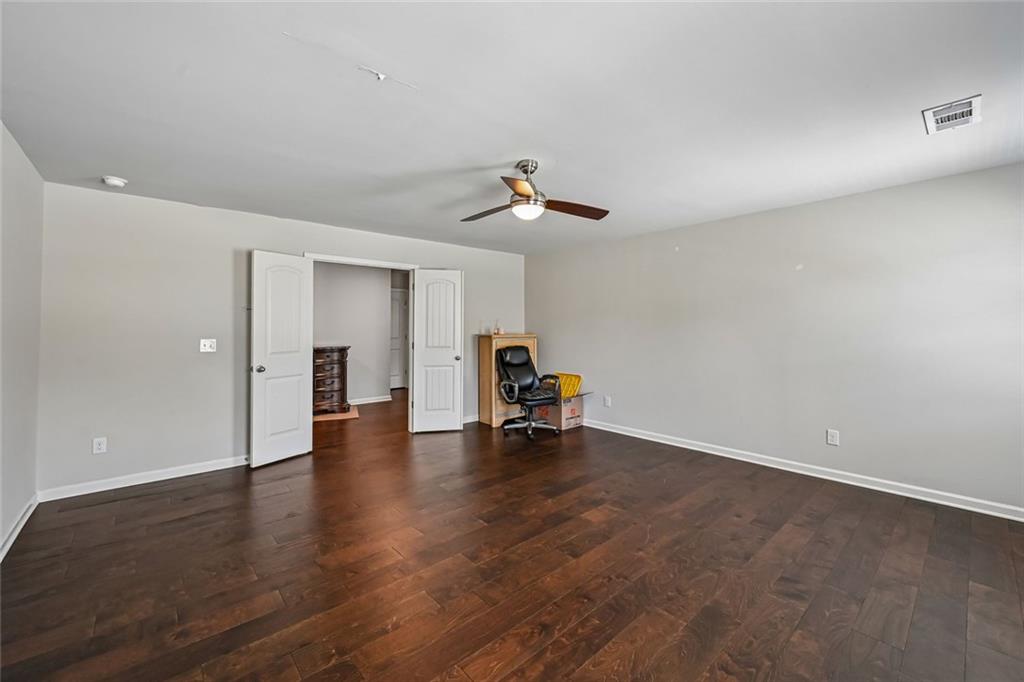5378 Silverwoods Walk Powder Springs, GA 30127 - Photo 44 of 62 a view of empty room with wooden floor and a cabinet
