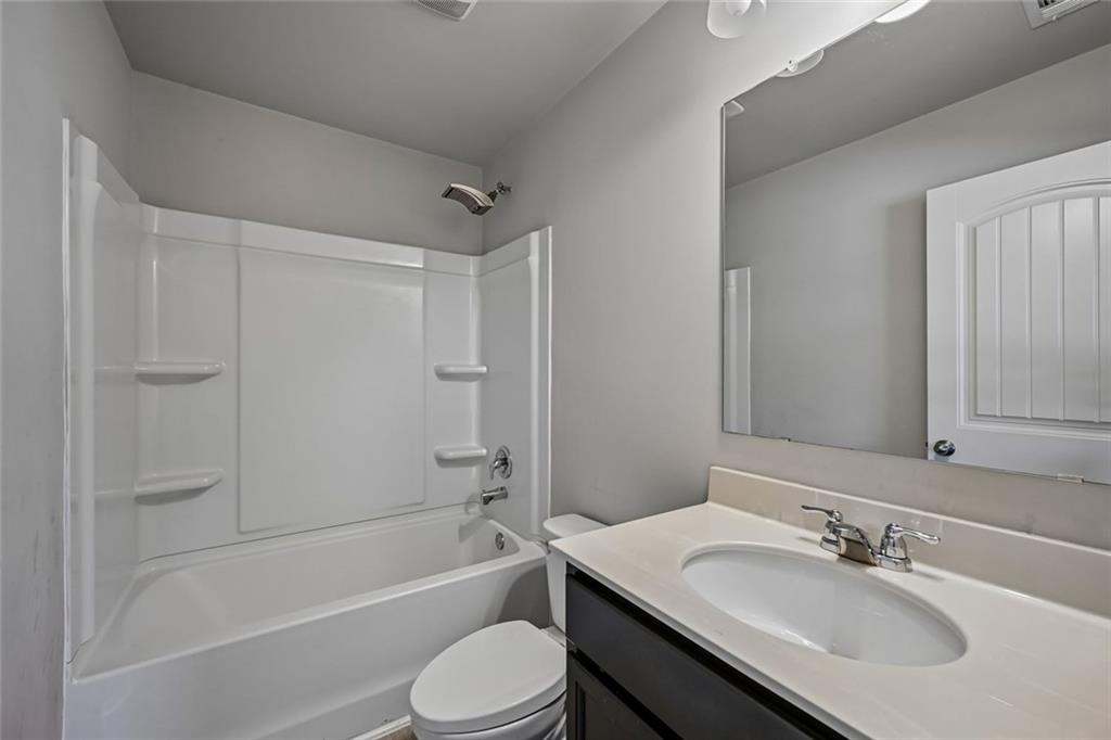 5378 Silverwoods Walk Powder Springs, GA 30127 - Photo 47 of 62 a bathroom with a sink toilet vanity and shower