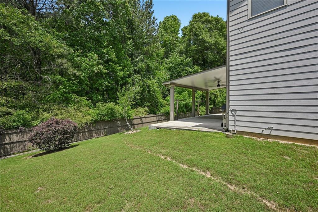 5378 Silverwoods Walk Powder Springs, GA 30127 - Photo 51 of 62 a view of a house with backyard and sitting area