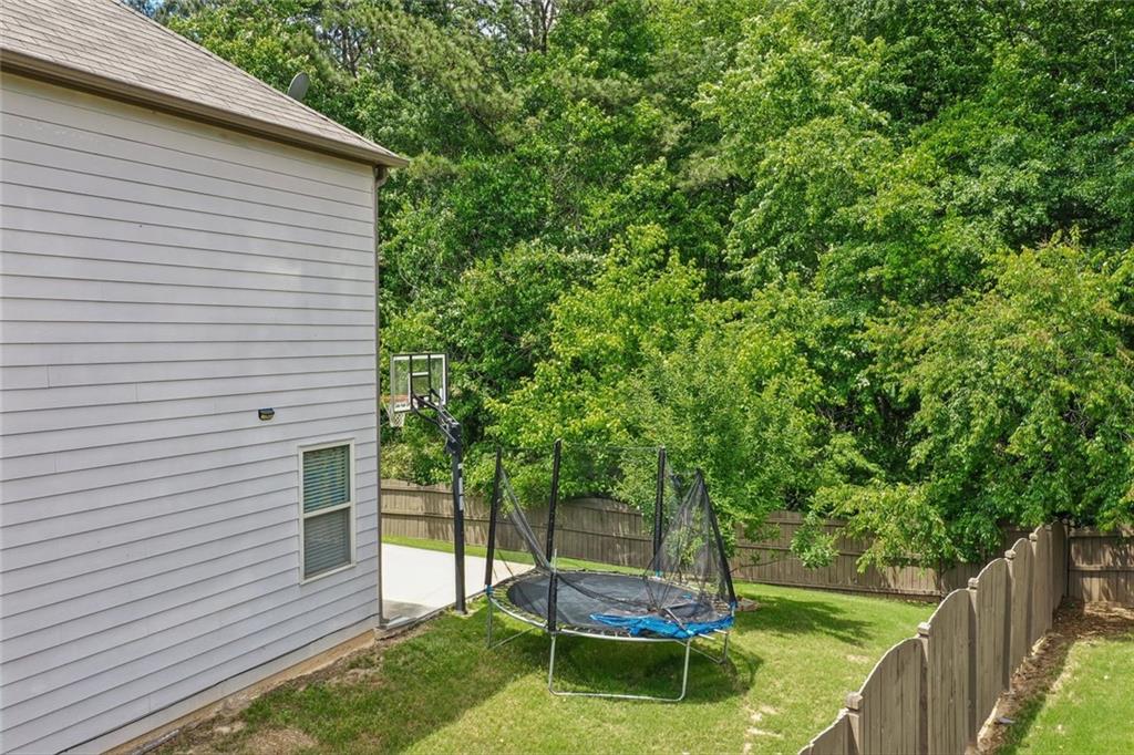 5378 Silverwoods Walk Powder Springs, GA 30127 - Photo 60 of 62 a backyard of a house with fountain table and chairs