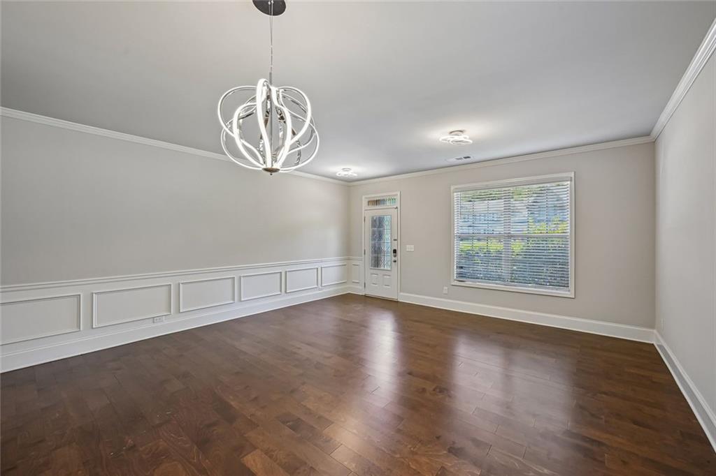 5378 Silverwoods Walk Powder Springs, GA 30127 - Photo 6 of 62 an empty room with wooden floor and windows