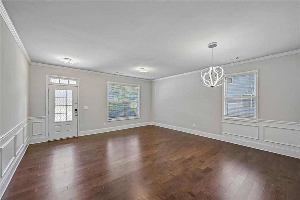 5378 Silverwoods Walk Powder Springs, GA 30127 - Photo 7 of 62 an empty room with wooden floor and windows
