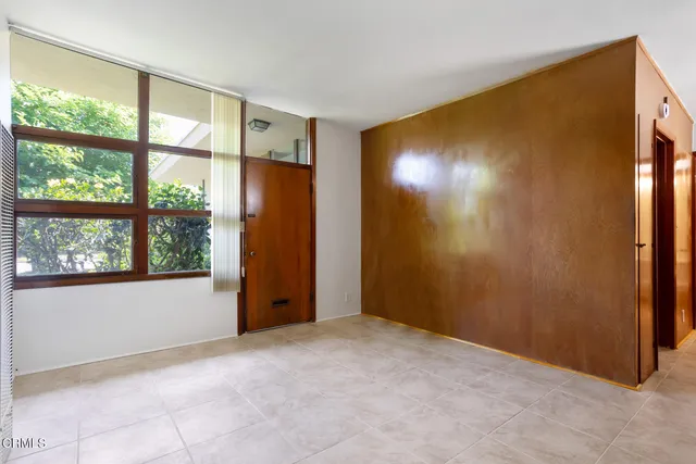 an empty room with windows and closet