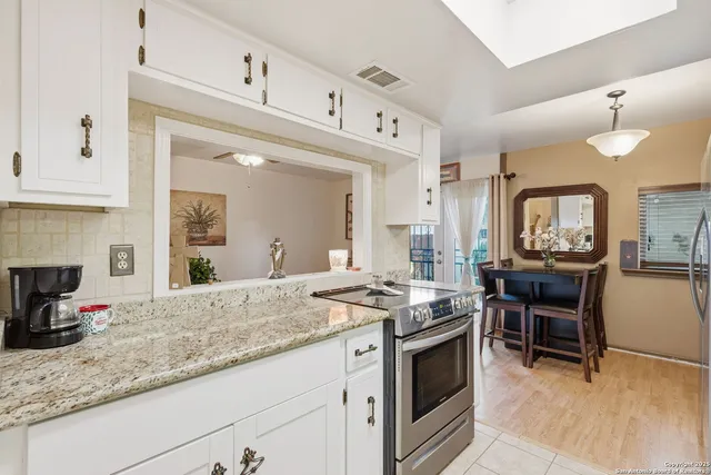 a kitchen with stainless steel appliances granite countertop a stove and a sink