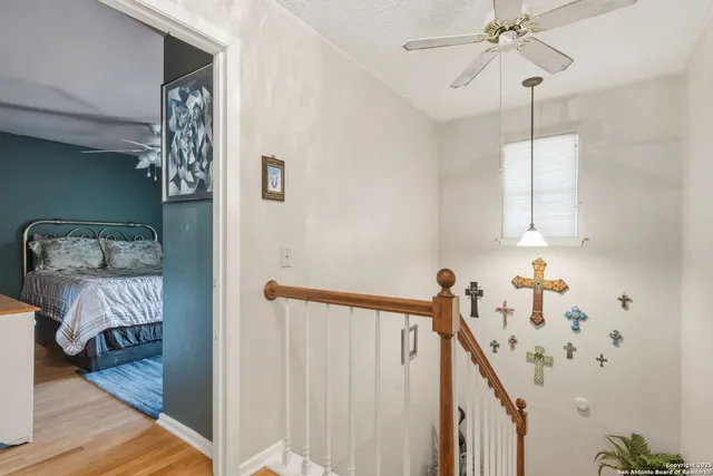 a view of a hallway to a livingroom with furniture