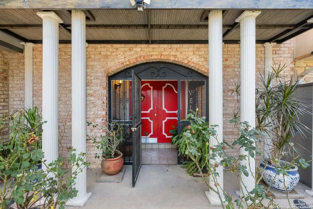a building with potted plants in front of door