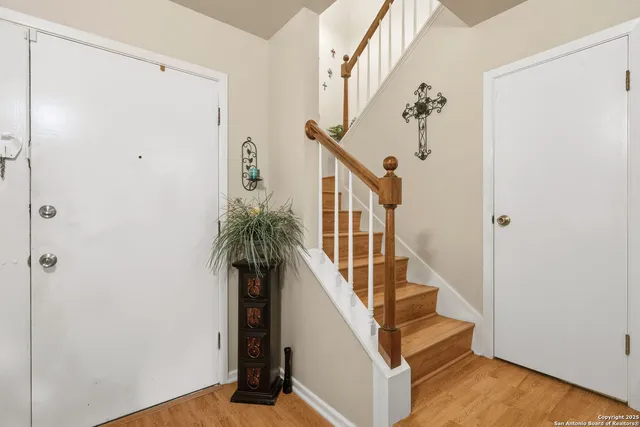a view of entryway with wooden floor and stairs