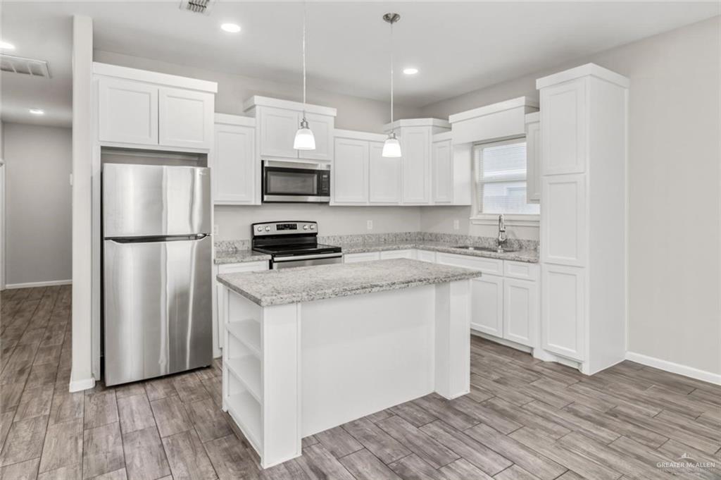 1000 Kentucky Street, Unit 1 Alton, TX 78573 - Photo 4 of 10 a kitchen with stainless steel appliances a refrigerator stove microwave and sink
