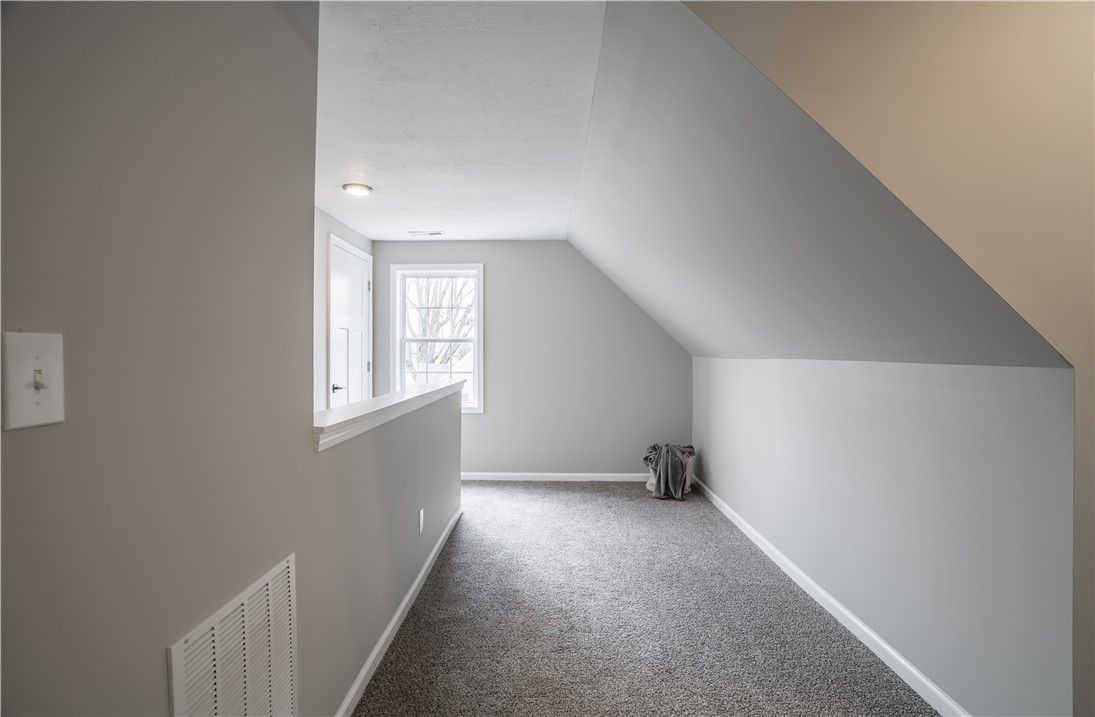 8240 Looney Road Piqua, OH 45356 - Photo 23 of 49 An inviting attic space with sloped ceilings awaits your creative touch.