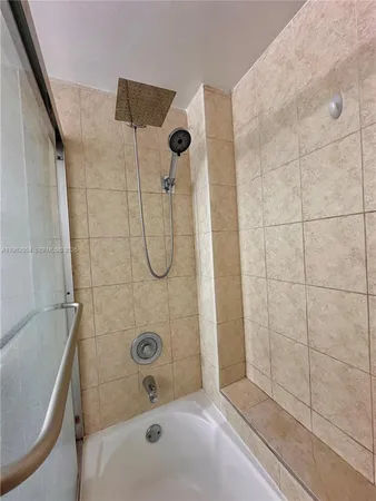 a bathroom with a bathtub and shower