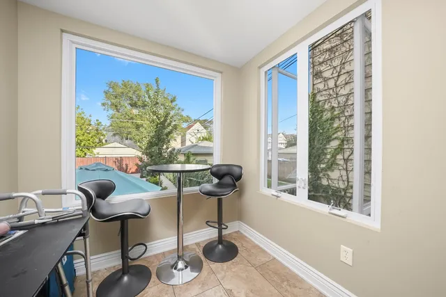 a view of a workspace with furniture and a window