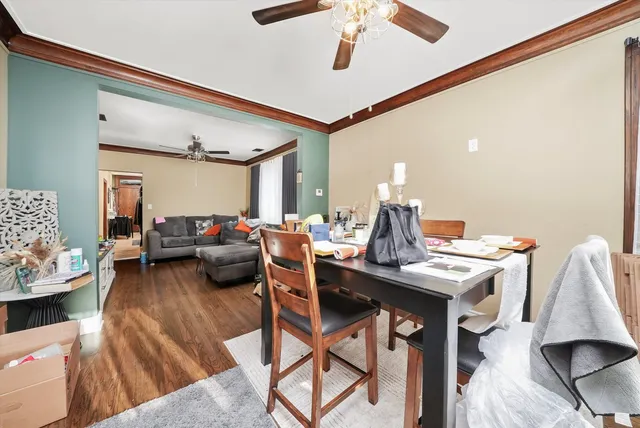 a view of a dining room with furniture and a chandelier