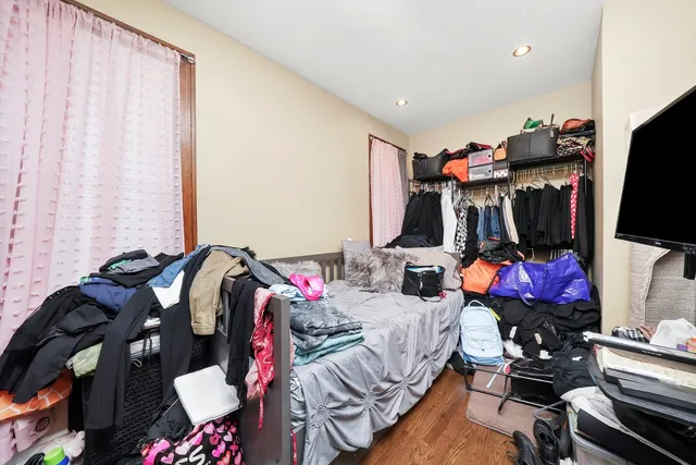 a living room with furniture a flat screen tv and a window