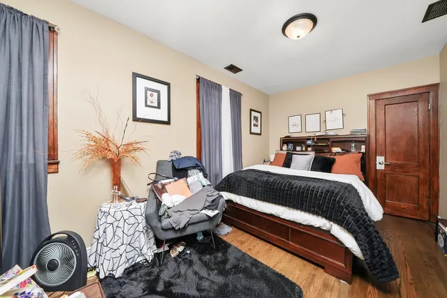 a bed room with a bed and a chair