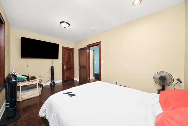 a bedroom with a bed and a flat screen tv