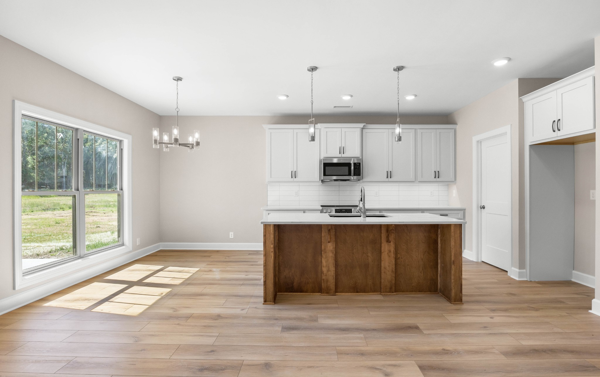 1456 Sango Commons Way Clarksville, TN 37043 - Photo 12 of 49 a large kitchen with stainless steel appliances granite countertop a stove a sink and a refrigerator