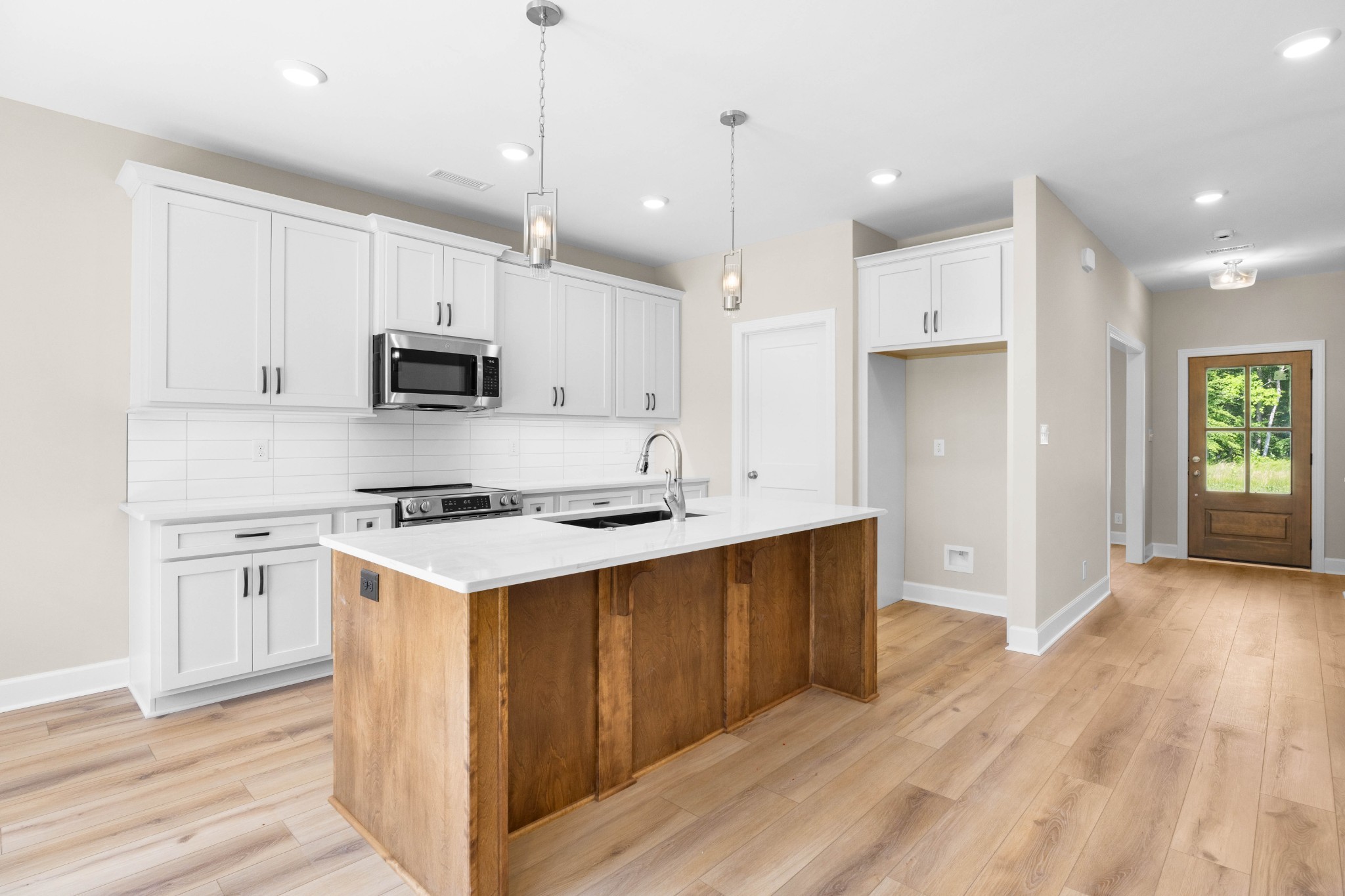 1456 Sango Commons Way Clarksville, TN 37043 - Photo 13 of 49 a kitchen with kitchen island a stove a sink a refrigerator and a microwave