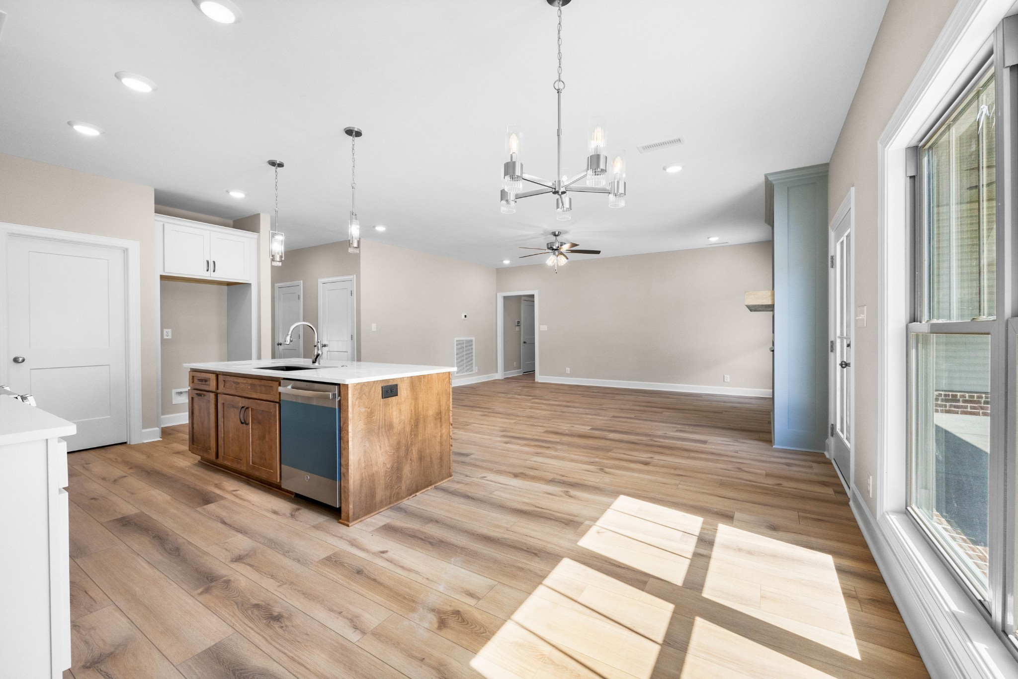 1456 Sango Commons Way Clarksville, TN 37043 - Photo 19 of 49 a large white kitchen with a large window a counter space a sink and cabinets