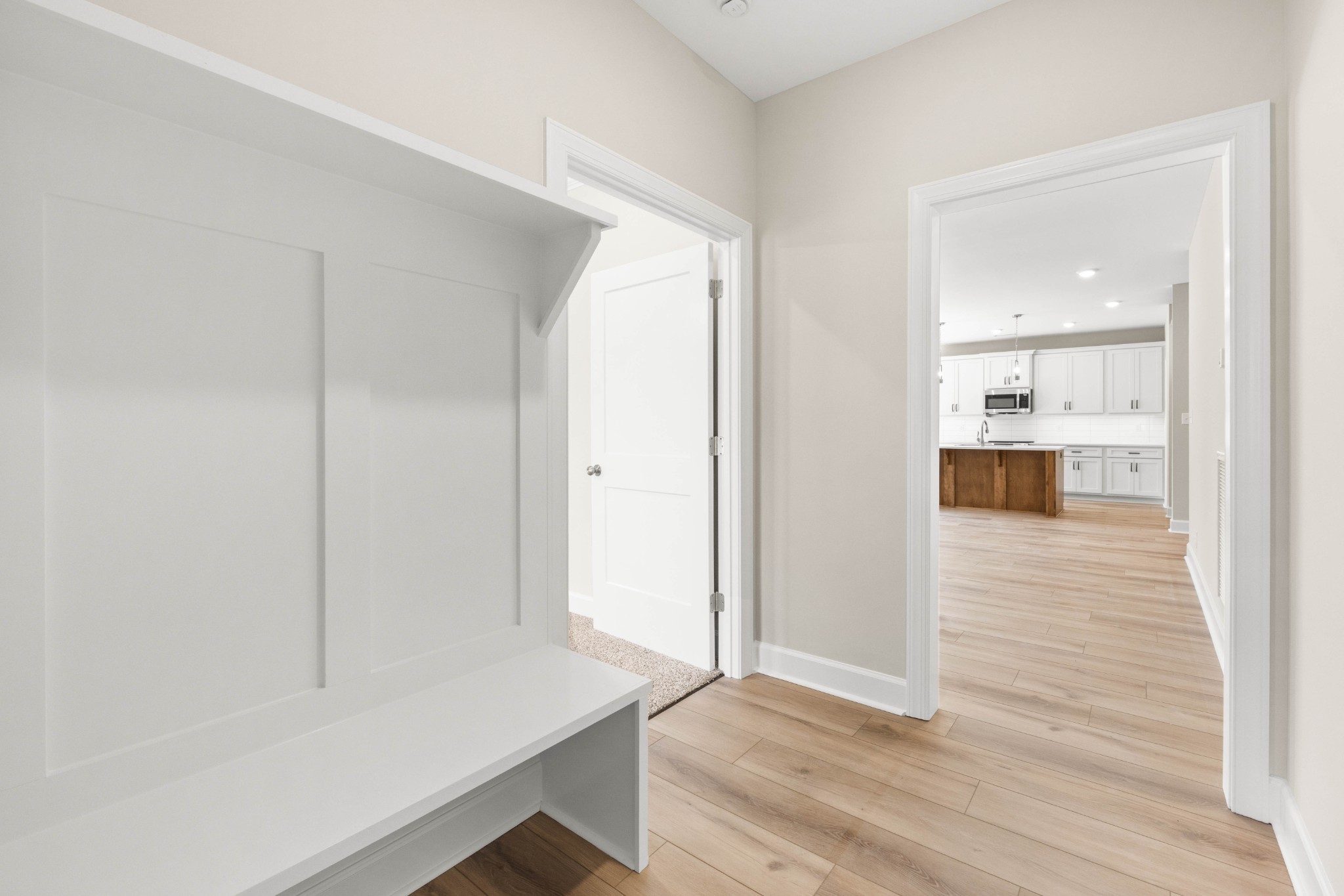 1456 Sango Commons Way Clarksville, TN 37043 - Photo 23 of 49 a view of a hallway with wooden floor and a kitchen space