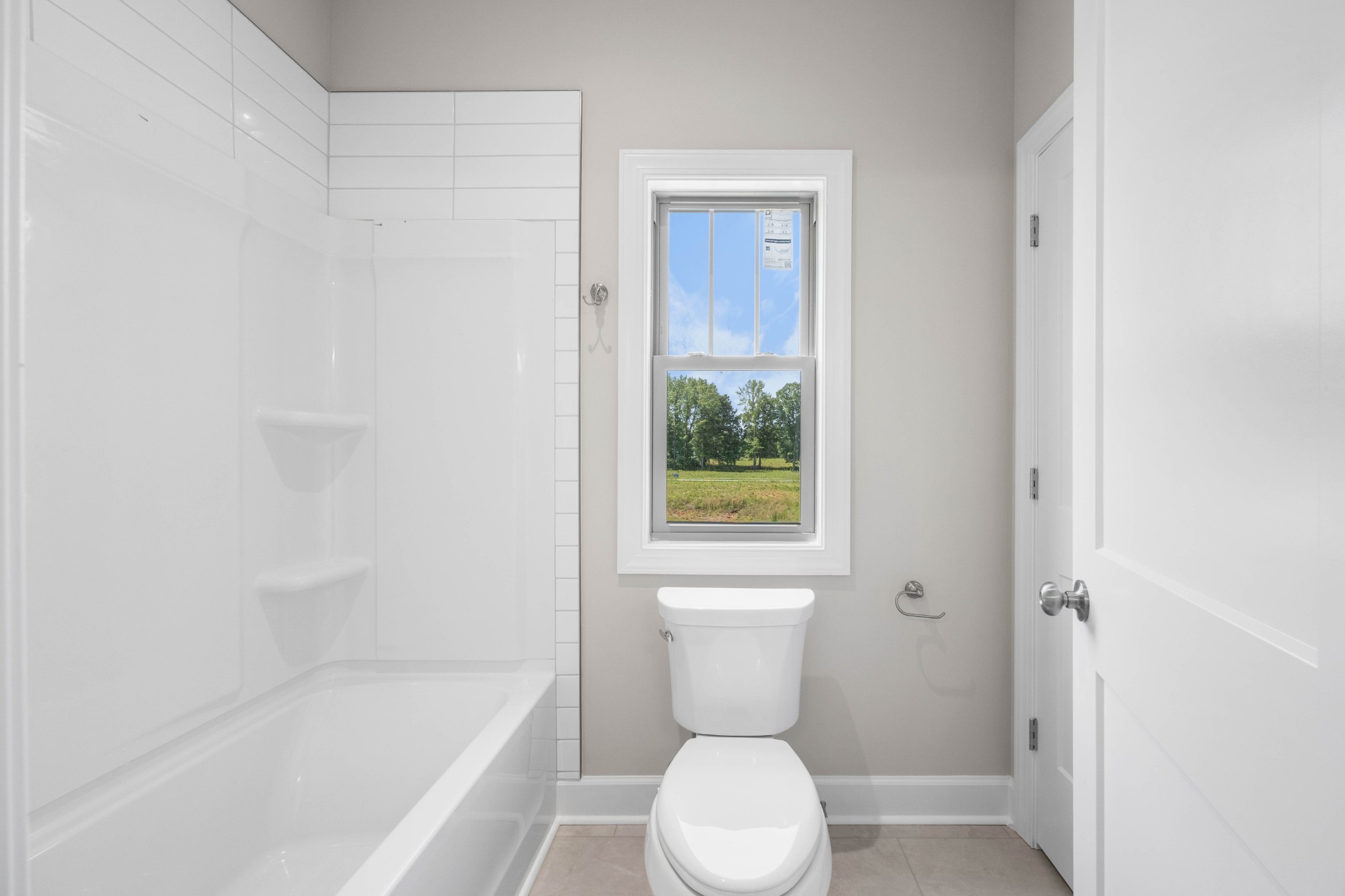 1456 Sango Commons Way Clarksville, TN 37043 - Photo 34 of 49 a white toilet sitting next to a bath tub