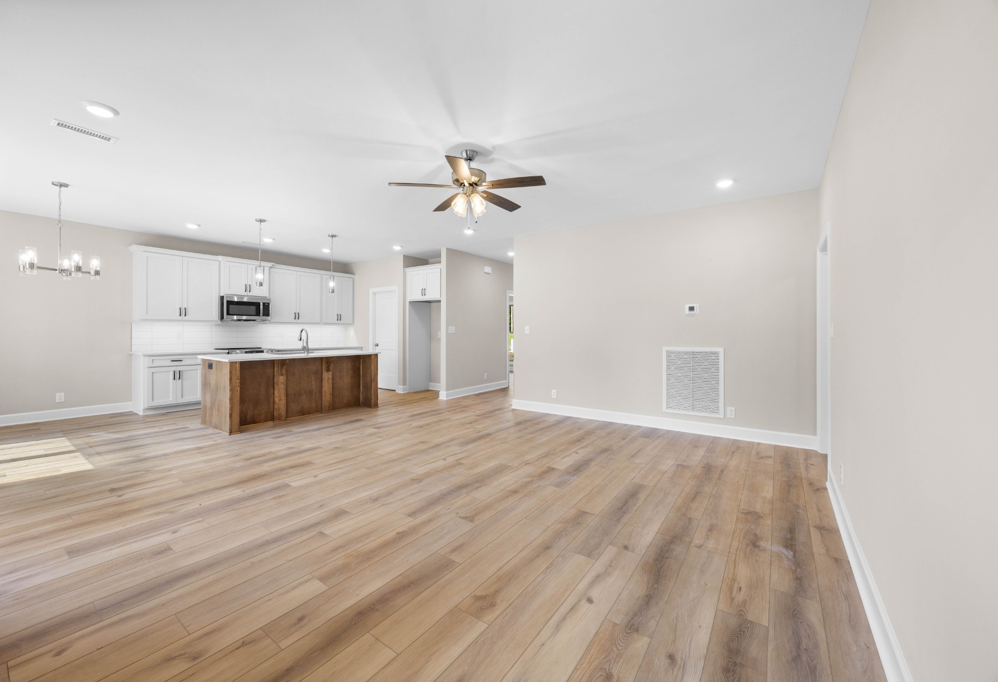 1456 Sango Commons Way Clarksville, TN 37043 - Photo 10 of 49 a view of kitchen and empty room with wooden floor