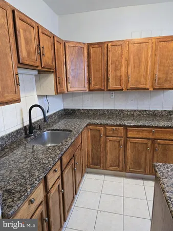 a kitchen with a sink a stove a microwave and cabinets