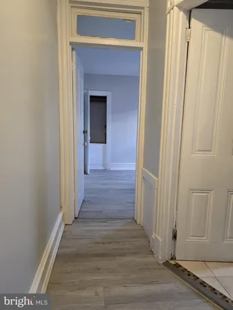 an empty room with wooden floor and a window