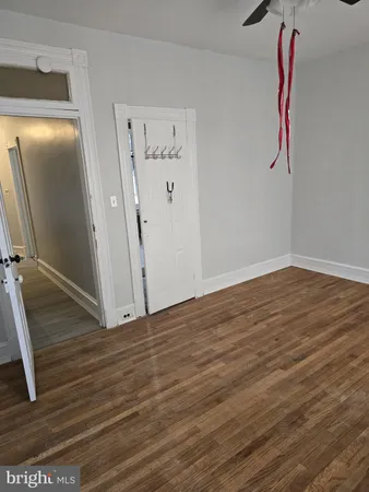 wooden floor in an empty room with a window
