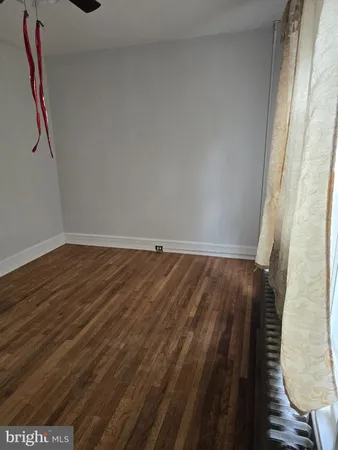 a view of hallway with wooden floor