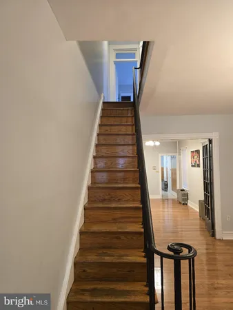 a view of entryway and hall with wooden floor